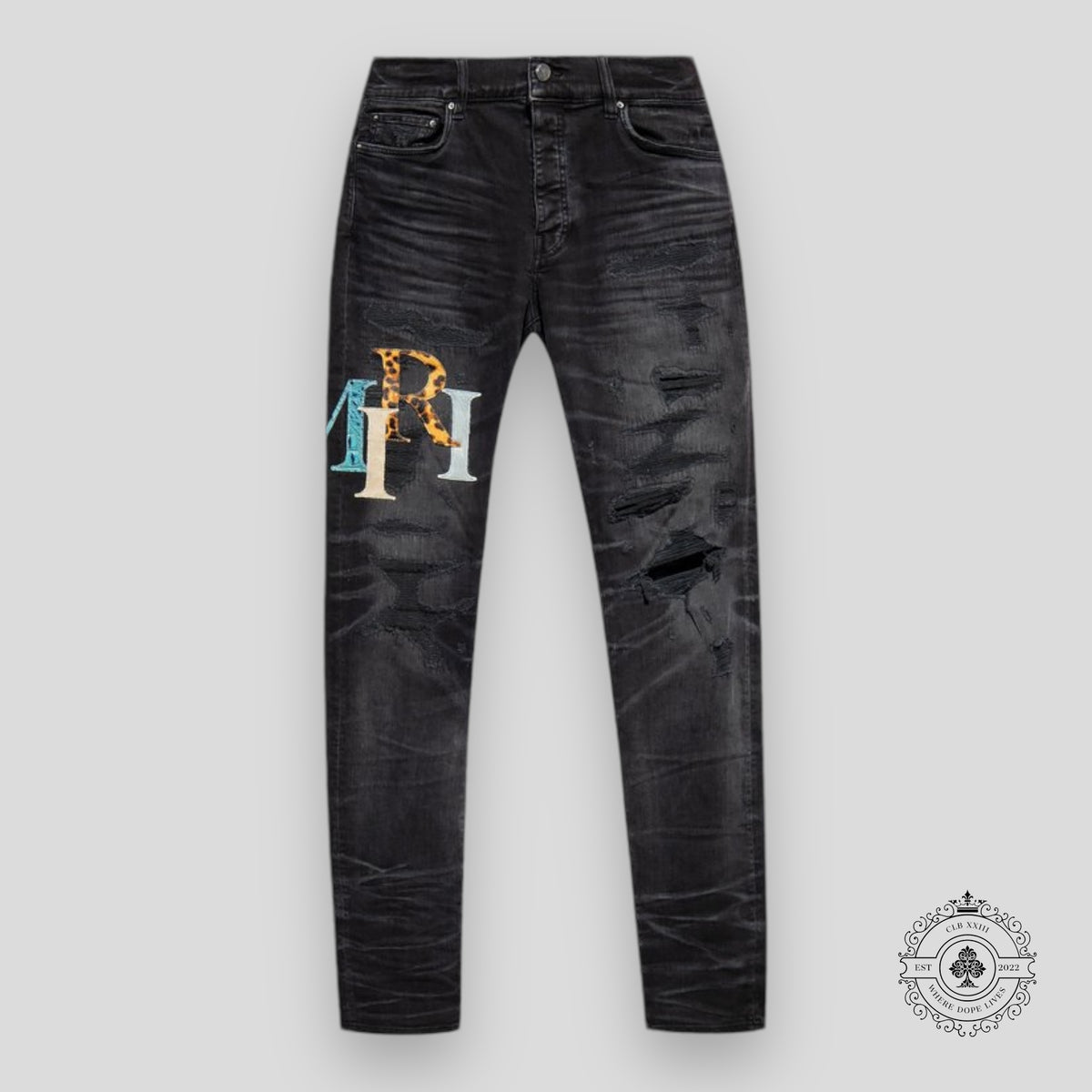 Amiri Staggered Logo Denim Jeans in Black