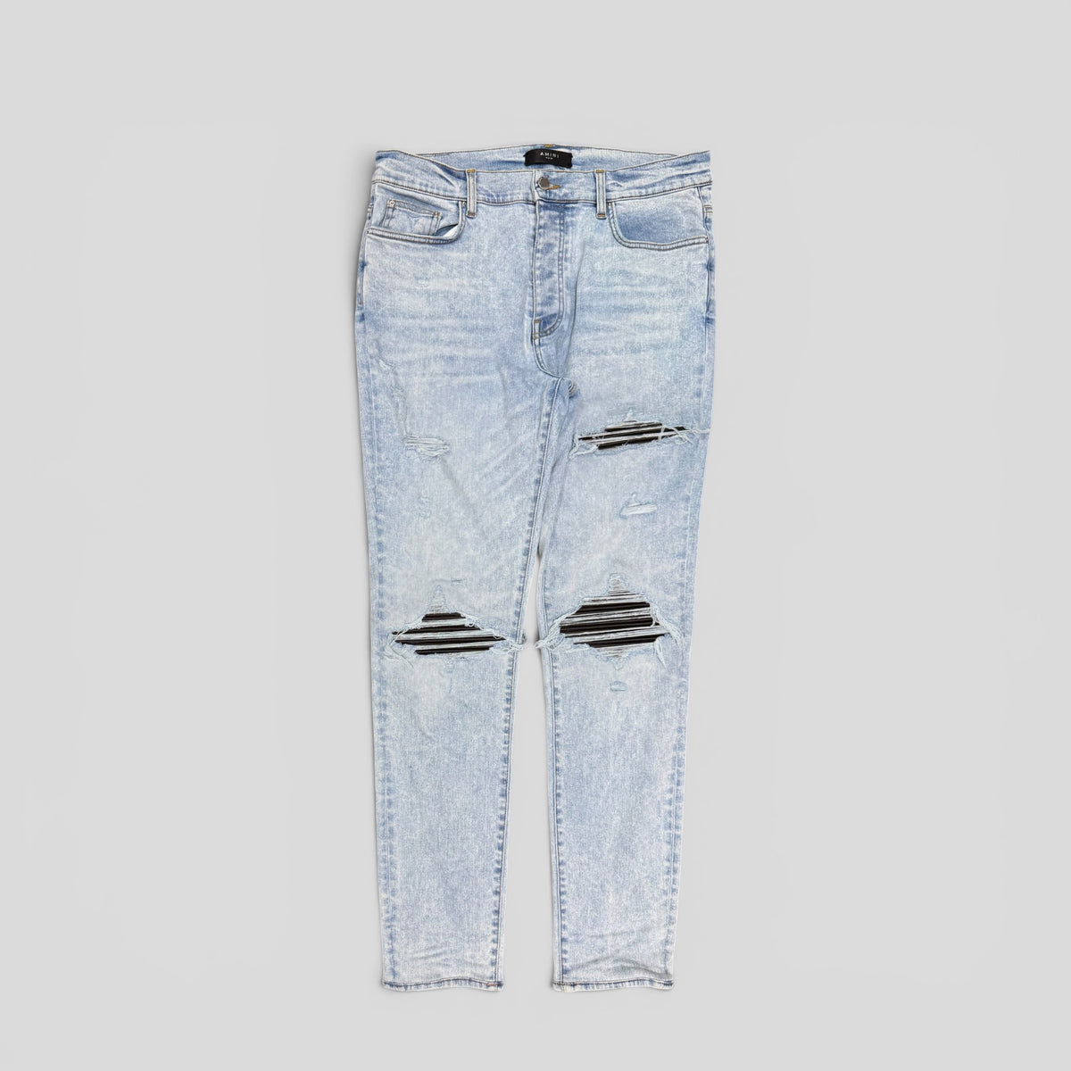 Amiri Leather Patch Thrasher Jeans in Light Wash / Black