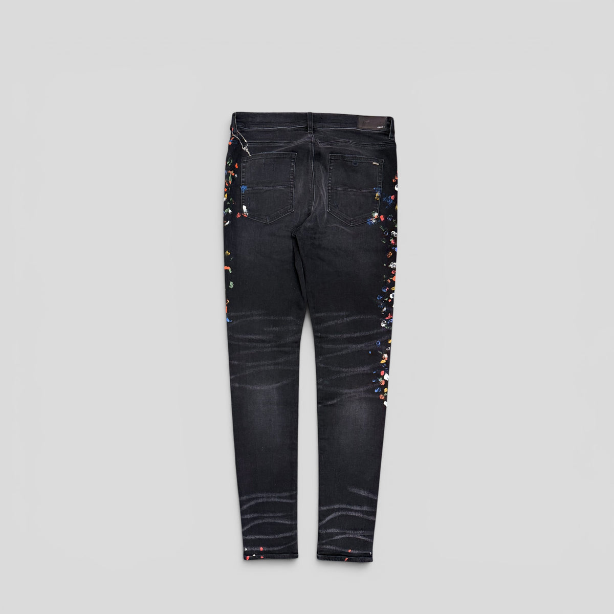 Amiri Distressed Paint Splatter Jeans in Aged Black