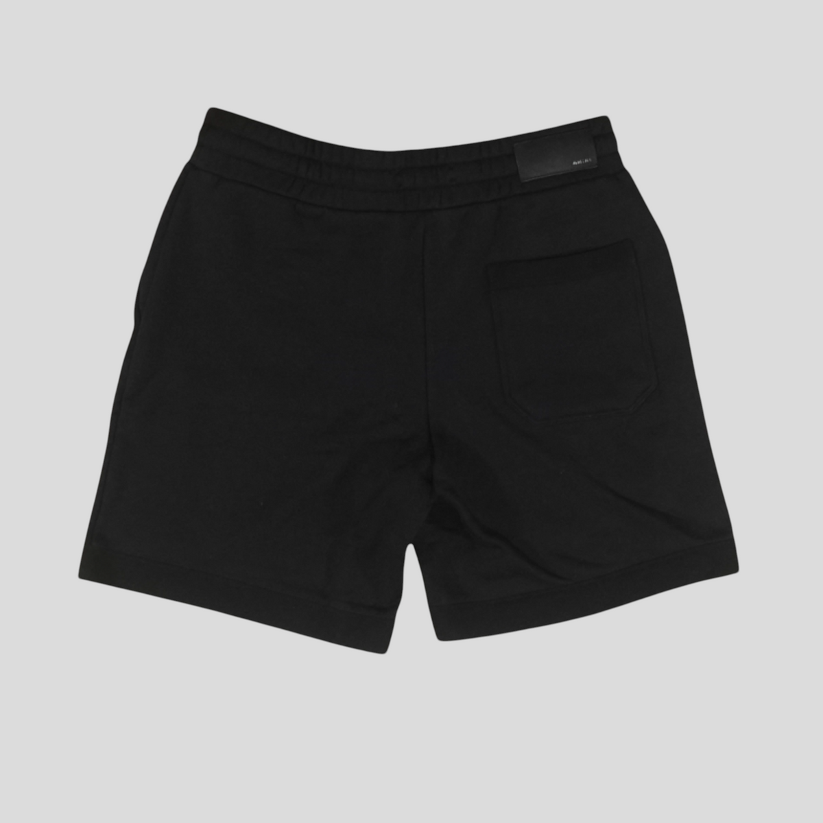 CLB XXIII Amiri black cotton sweatshorts with a back pocket and branded patch, shown from the rear view.