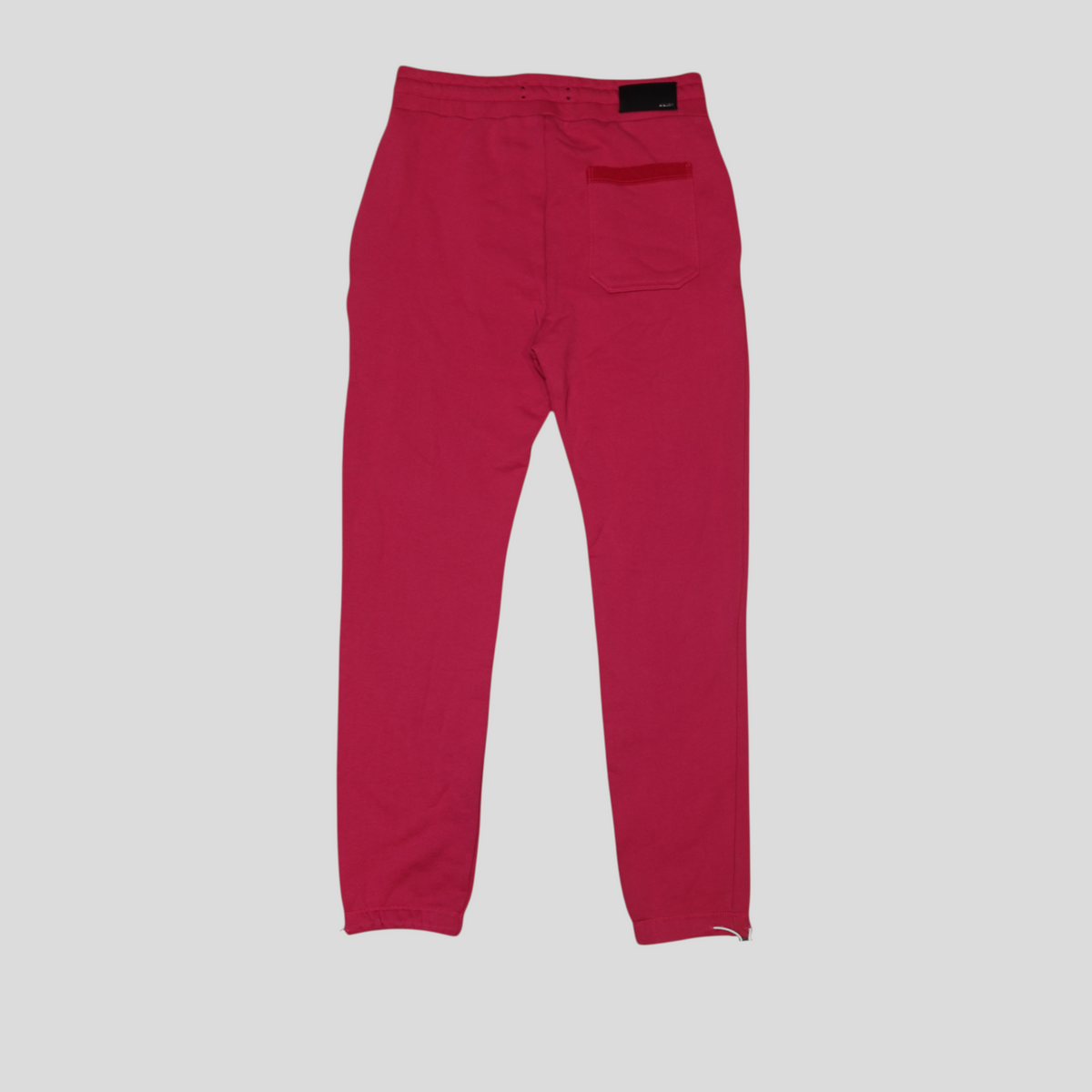 CLB XXIII pink Amiri cotton sweatpants featuring a back pocket and elasticated waistband, back view.