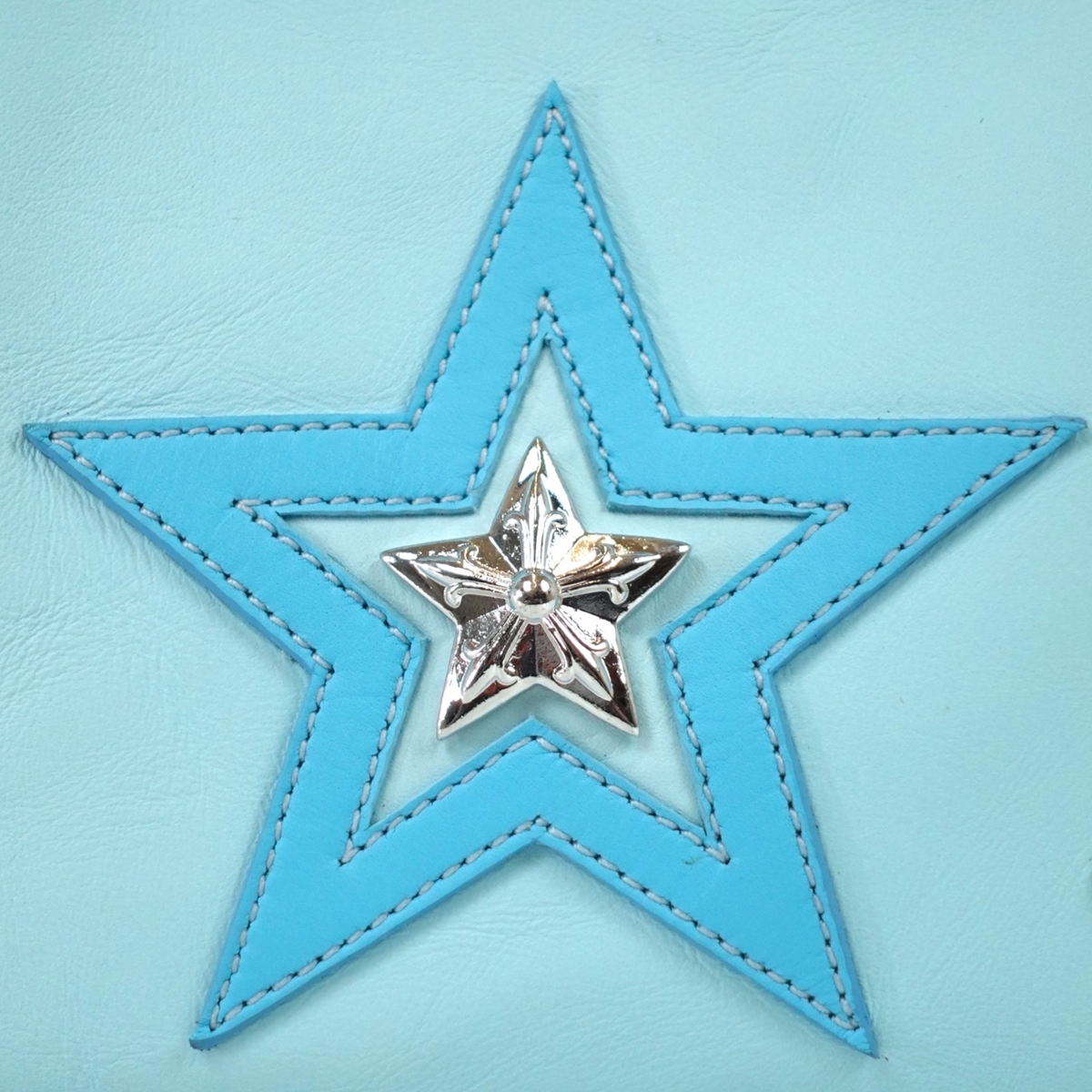 CLB XXIII Chrome Hearts blue leather star patch with a detailed silver star emblem on a textured leather background