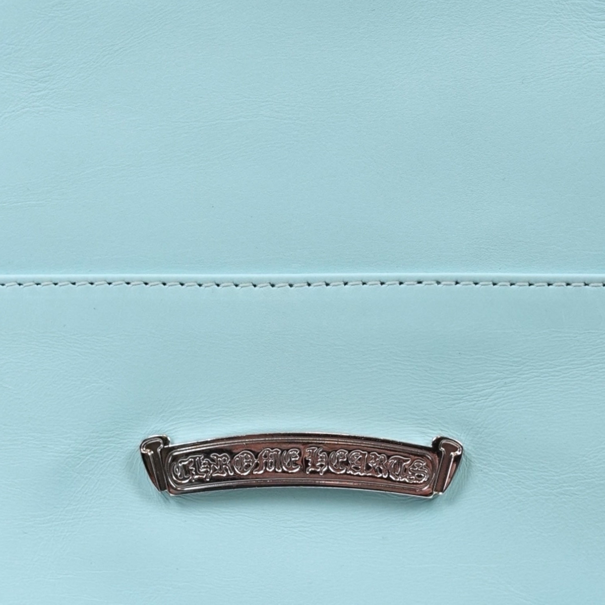 CLB XXIII Chrome Hearts light blue leather tote bag featuring a detailed silver logo plaque with intricate engraving.