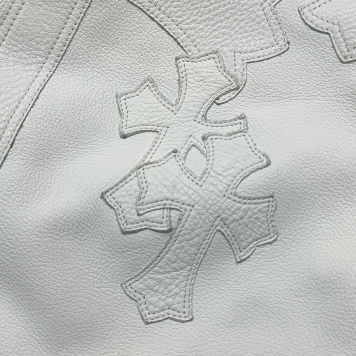 CLB XXIII Chrome Hearts white leather bean bag chair featuring detailed stitched cross patterns on textured leather