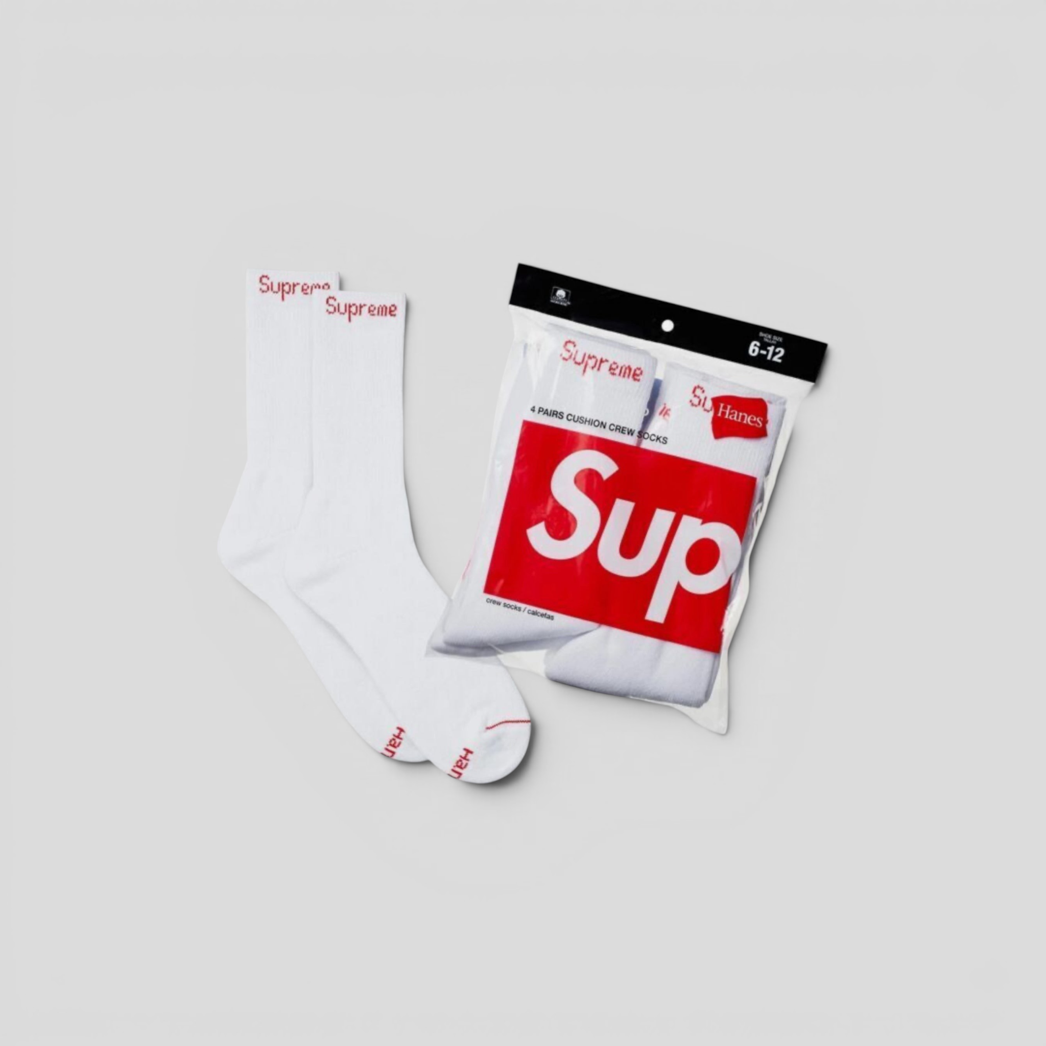 CLB XXIII white Supreme Hanes crew socks with red box logo on ribbed ankle, shown with original packaging.