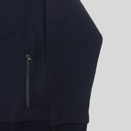 CLB XXIII navy blue jacket featuring an embroidered monogram pattern and a zippered pocket detail.