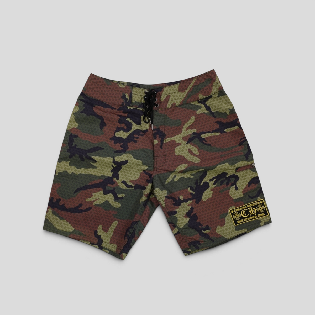 CLB XXIII Chrome Hearts board shorts in green and brown camouflage polyamide with a black lace-up front closure.