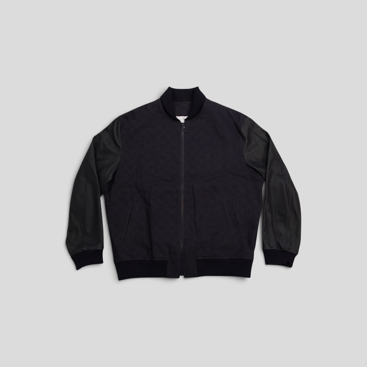 CLB XXIII Louis Vuitton black bomber jacket featuring cotton body, leather sleeves, and ribbed trim details.