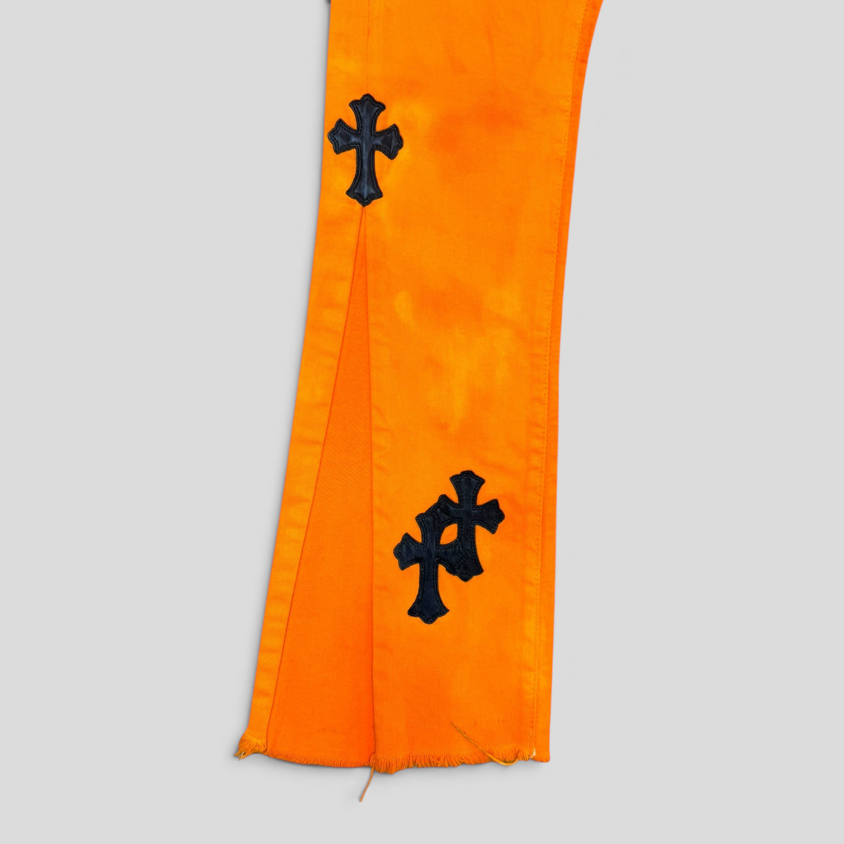 CLB XXIII orange cotton flare jeans featuring black cross patches and sterling silver hardware details.