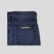 CLB XXIII Chrome Hearts dark wash denim shorts featuring a signature silver cross patch on the back pocket