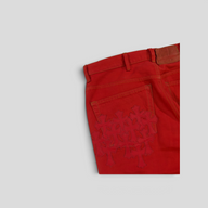 CLB XXIII red denim jeans featuring tonal leather cross patches on the back pocket and silver hardware details.