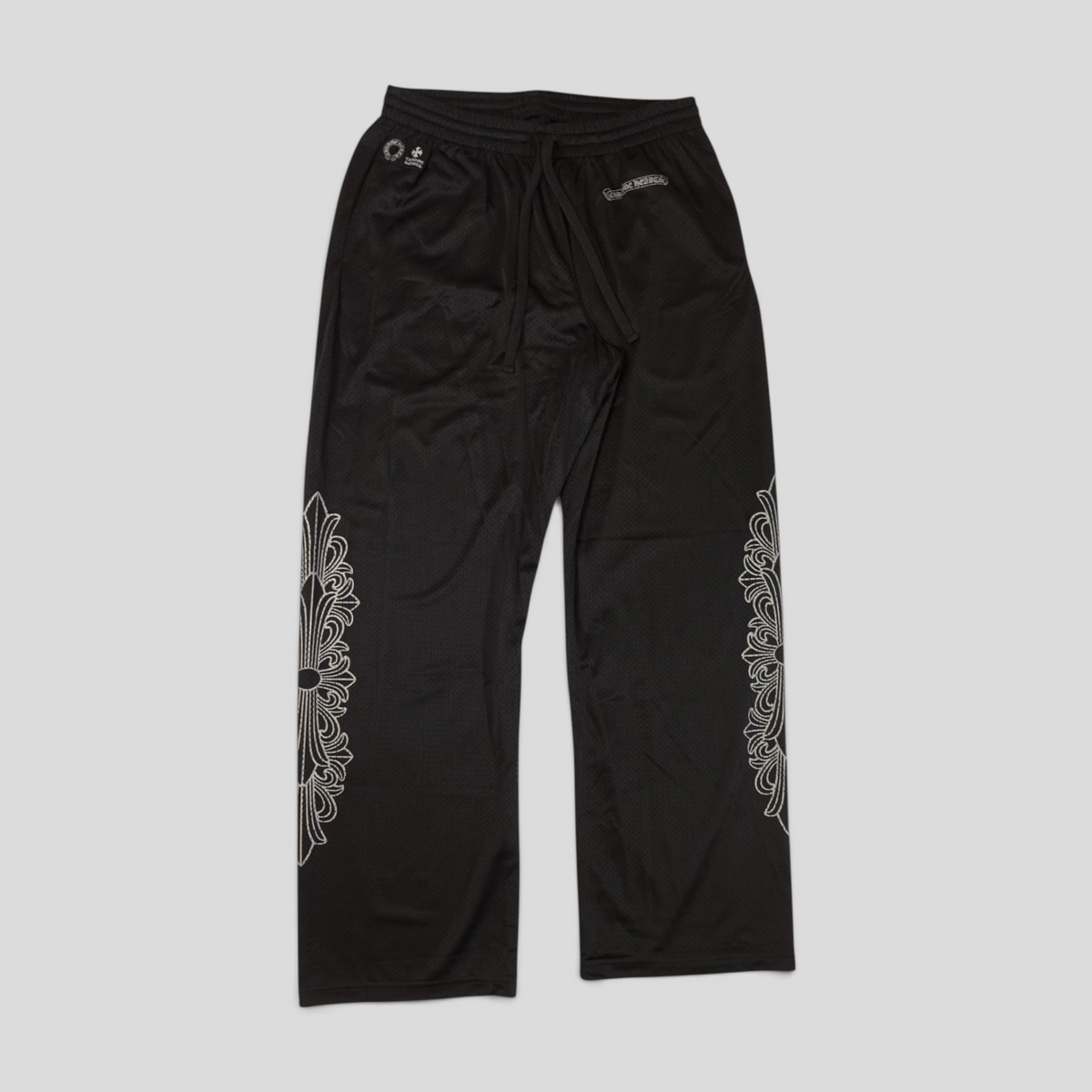 CLB XXIII black nylon mesh pants featuring white Chrome Hearts floral graphic prints and an elastic drawstring waist