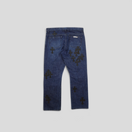 CLB XXIII Chrome Hearts dark wash denim jeans featuring black fleur knee cross patches on the back view.