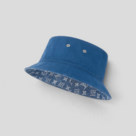 CLB XXIII reversible blue cotton denim bucket hat featuring a jacquard-woven monogram pattern on the brim underside.