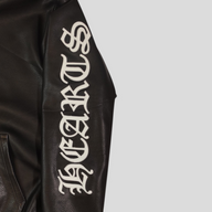 CLB XXIII Chrome Hearts black leather hoodie sleeve featuring white gothic lettering embroidery