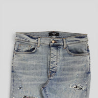 Amiri Pajama Art Patch Jeans in Light Vintage