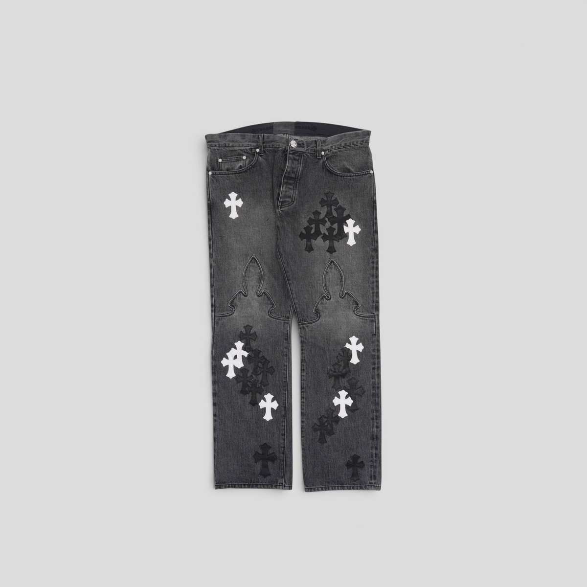 CLB XXIII black denim jeans featuring white and black fleur cross patches on the knees and legs
