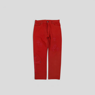 CLB XXIII Chrome Hearts Levi red cotton jeans featuring leather cross patches and silver hardware details.