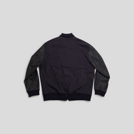 Back view of a CLB XXIII Louis Vuitton watercolor monogram bomber jacket in black cotton and leather.