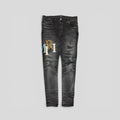 Amiri Staggered Logo Denim Jeans in Black