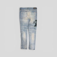 Amiri X Wes Lang Reaper Logo Jeans in Clay Indigo