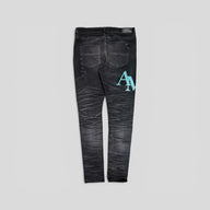 Amiri Staggered Logo Denim Jeans in Black