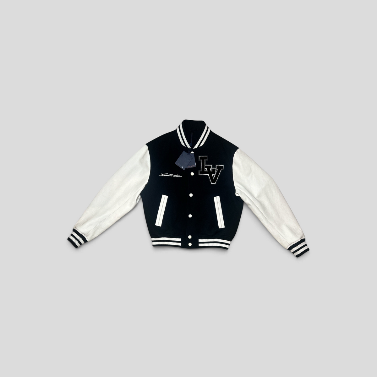 CLB XXIII Louis Vuitton Marque Deposee black and white wool varsity jacket with leather sleeves and LV logo detail.