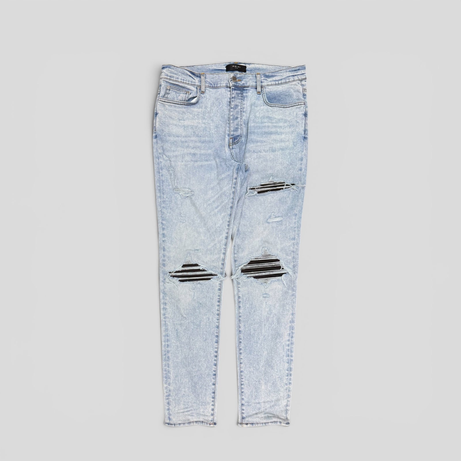 Amiri Leather Patch Thrasher Jeans in Light Wash / Black