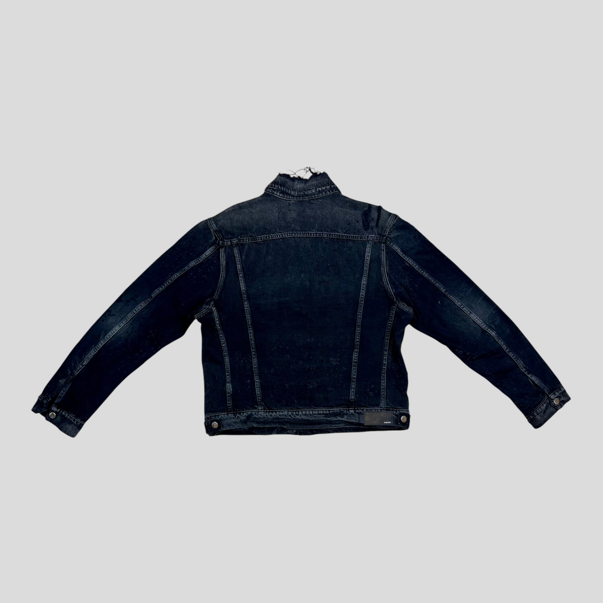 CLB XXIII AMIRI Shotgun denim trucker jacket in aged black cotton with distressed collar detail, back view.