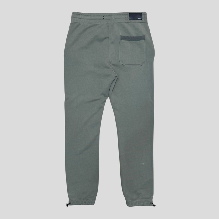 Back view of CLB XXIII Amiri green cotton sweatpants featuring a rear pocket and adjustable drawstring cuffs.
