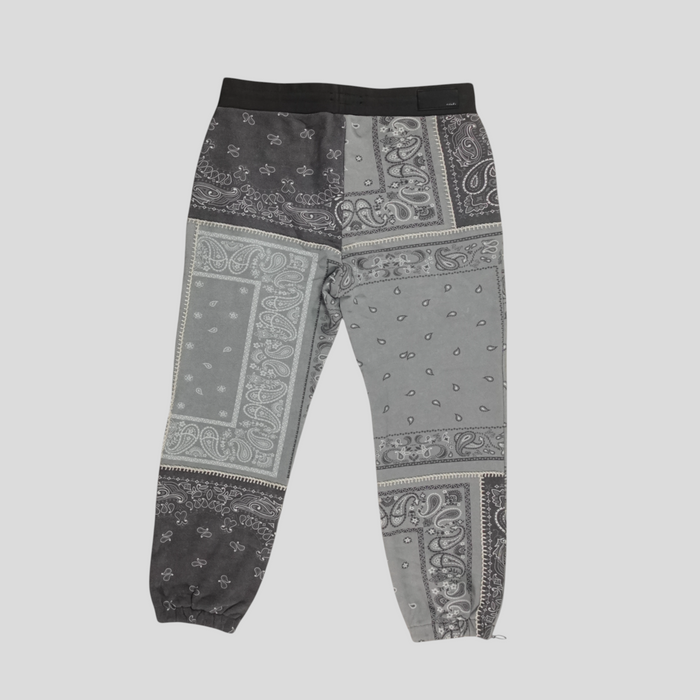 CLB XXIII Amiri grey cotton sweatpants featuring a patchwork bandana print design with a black elastic waistband.