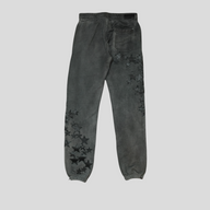 CLB XXIII Amiri grey cotton sweatpants featuring black leather star patches on the legs and a back pocket.