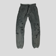 CLB XXIII Amiri grey cotton sweatpants featuring black leather star patches and a drawstring waist.