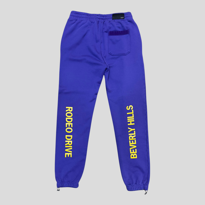 CLB XXIII Amiri purple cotton sweatpants with yellow Rodeo Drive Beverly Hills print and back pocket detail