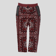 CLB XXIII Amiri red bandana print fleece pants with black leather zippered pockets and an elastic drawstring waist.