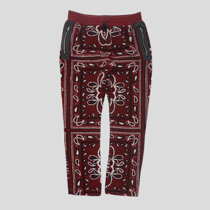 CLB XXIII Amiri red bandana print fleece pants with black leather zippered pockets and an elastic drawstring waist.