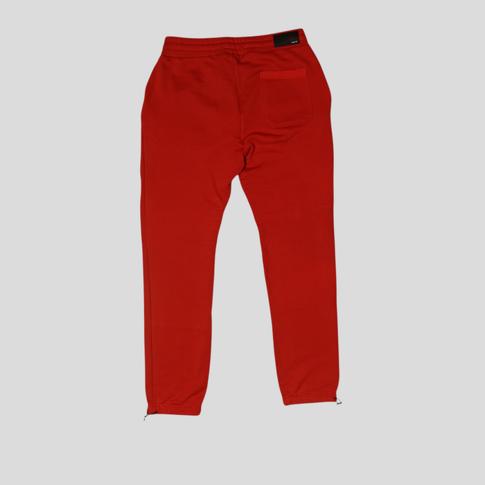 CLB XXIII Amiri red cotton sweatpants with back pocket and drawstring cuffs, shown from the back.