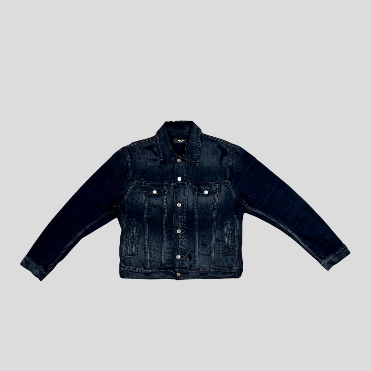 CLB XXIII AMIRI Shotgun denim trucker jacket in aged black cotton with distressed detailing and silver button closure.