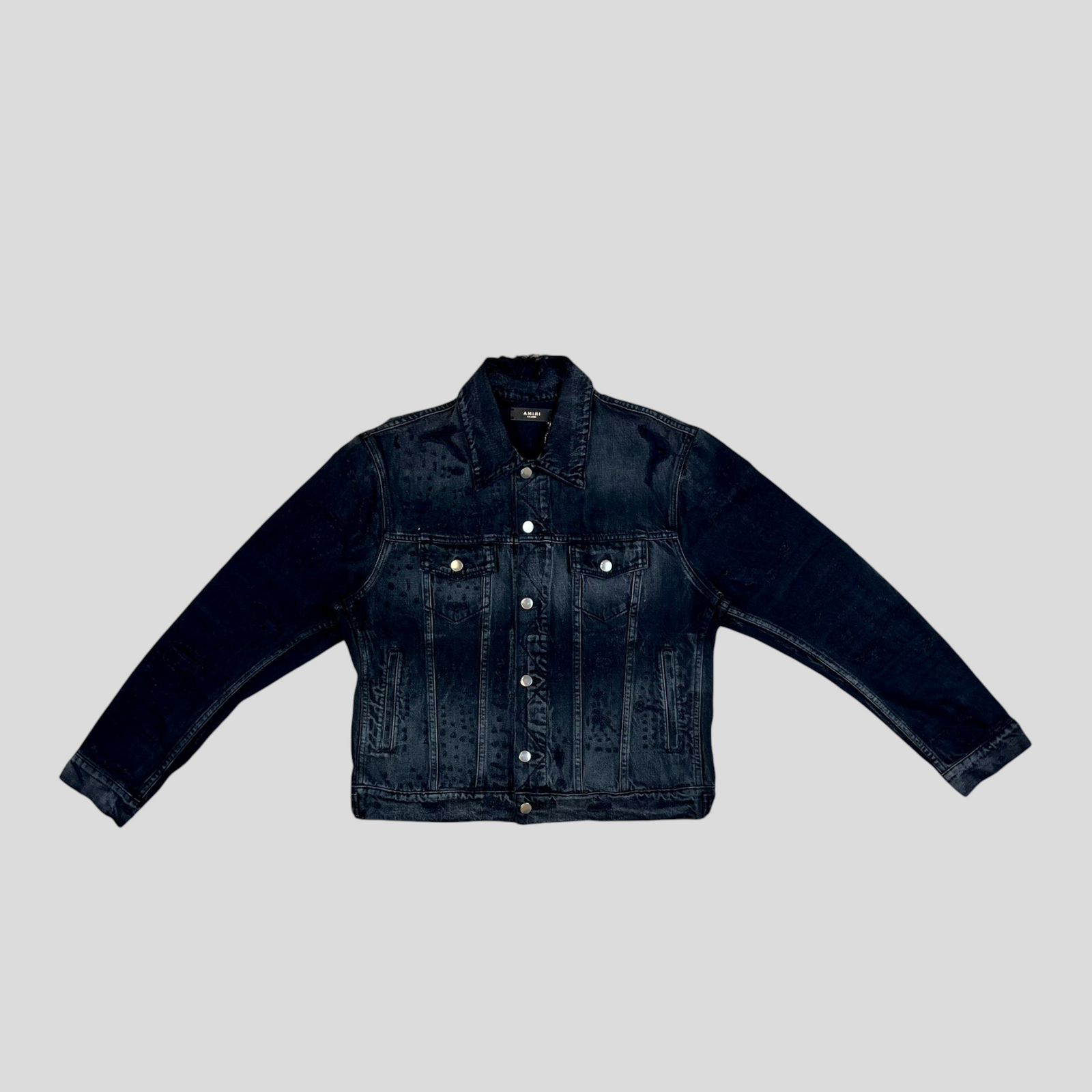 CLB XXIII AMIRI Shotgun denim trucker jacket in aged black cotton with distressed detailing and silver button closure.