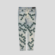CLB XXIII Amiri Chemist star patch jeans in clay indigo denim with dark green star appliqués, back view.