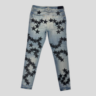 CLB XXIII Amiri Chemist star patch jeans in clay indigo denim with black leather star appliqués, back view.