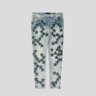 CLB XXIII Amiri Chemist star patch jeans in clay indigo denim with dark green star appliques and distressed details.