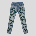 CLB XXIII Amiri Chemist light indigo denim jeans featuring dark green star patches and a slim fit design.