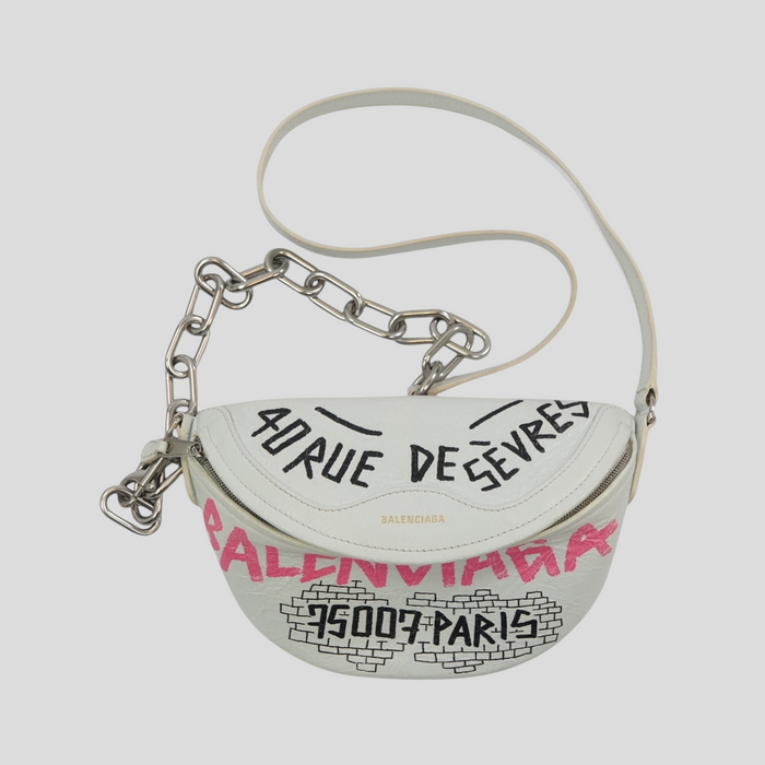CLB XXIII white leather Balenciaga XS Souvenir belt bag with black and pink graffiti print and silver chain strap.