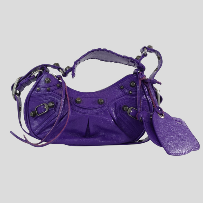 CLB XXIII Balenciaga Le Cagole XS shoulder bag in purple leather with silver-tone stud hardware and heart mirror tag.