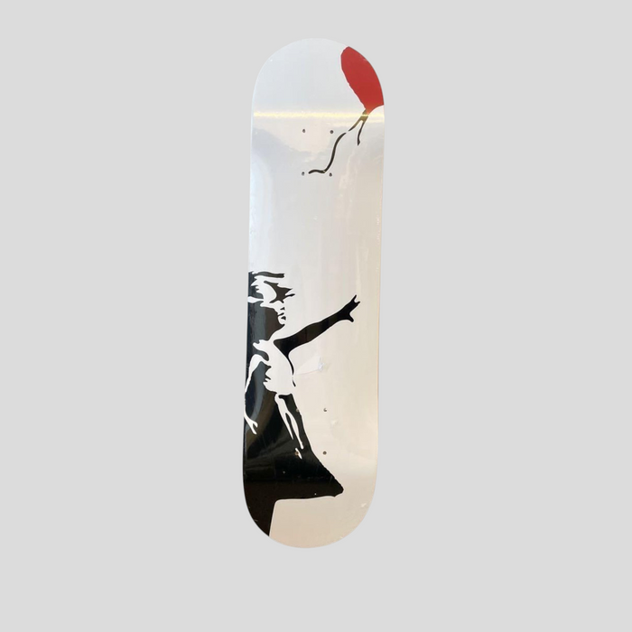 CLB XXIII Banksy Girl With Balloon skate deck featuring a black silhouette of a girl reaching for a red heart balloon