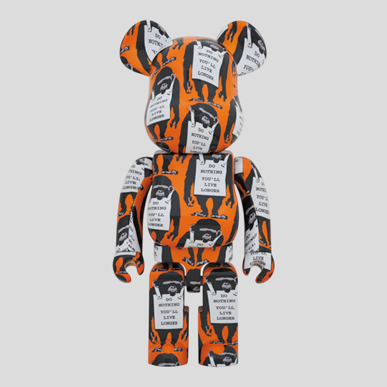 CLB XXIII 1000% Bearbrick Banksy Monkey Sign figure in orange, white, and black with iconic monkey graphic print.