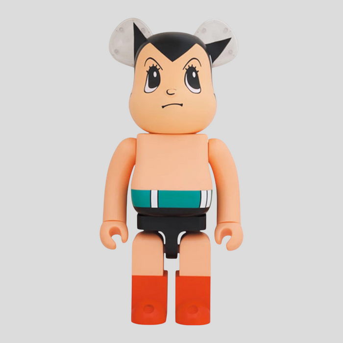 CLB XXIII 1000% Bearbrick Astro Boy Brave collectible figure in tan with iconic black hair and red boots