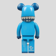 CLB XXIII 1000% Bearbrick Kaws Chomper figure in blue with white teeth, back view showing collectible branding