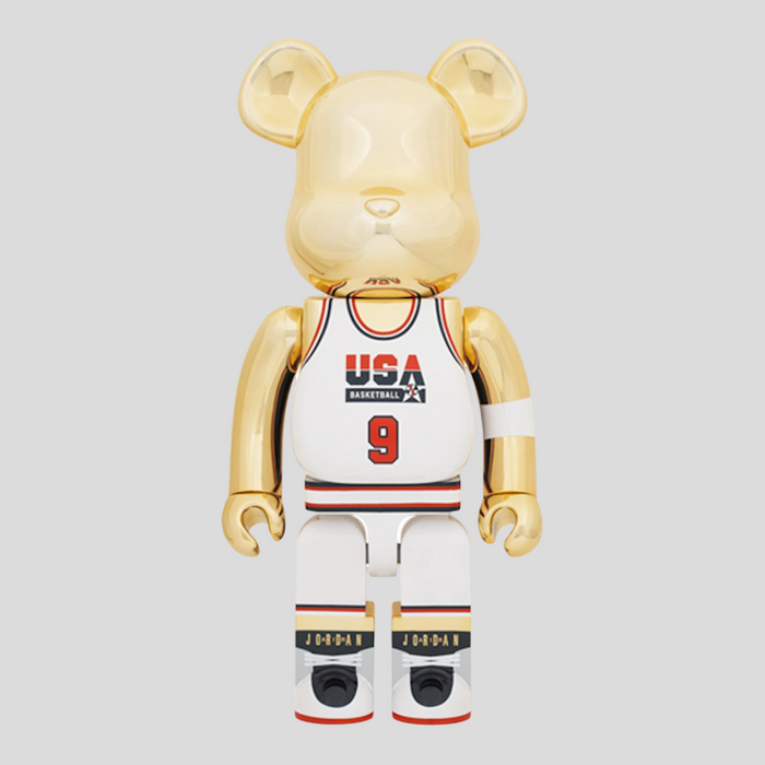 CLB XXIII 1000% Bearbrick Michael Jordan 1992 Team USA figure in gold, white, red, and navy with basketball jersey